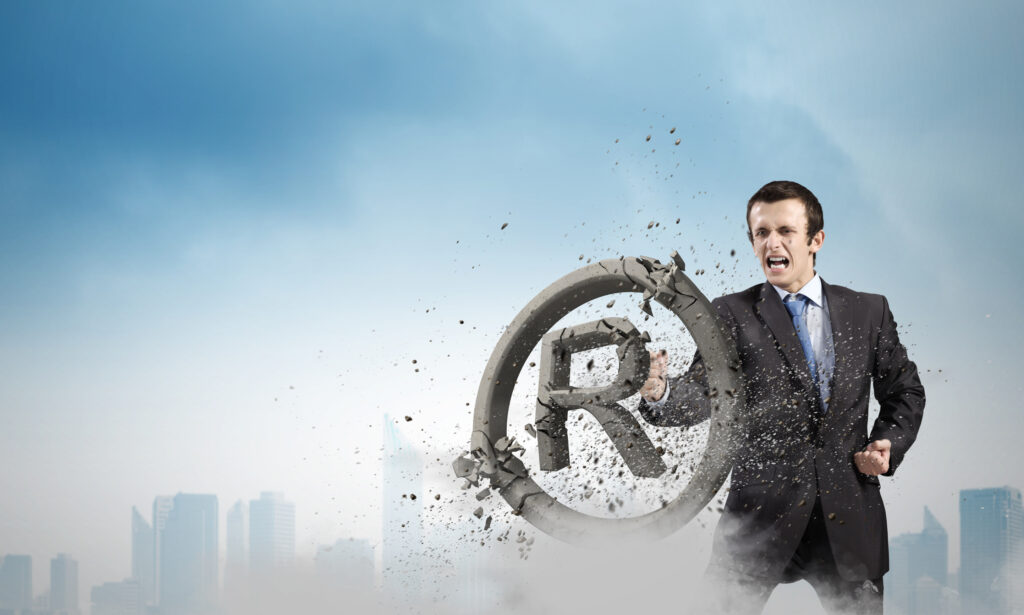 corporate man punching the letter R