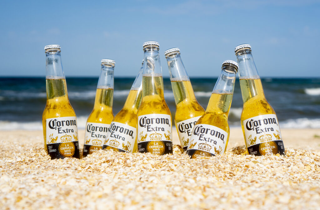 bottles of corona extra beer in sand