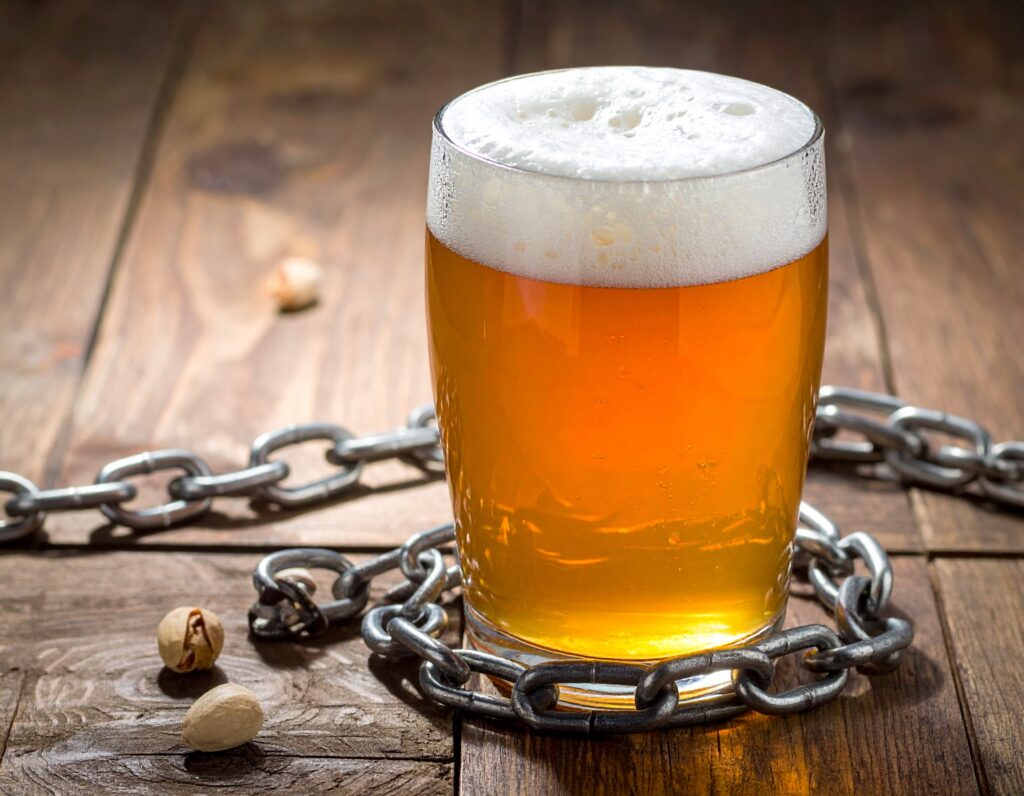 glass of beer surrounded by chains