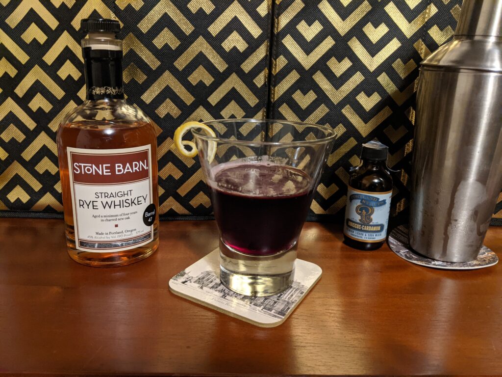 stone barn rye whiskey bottle with pitcher of mixed drinks