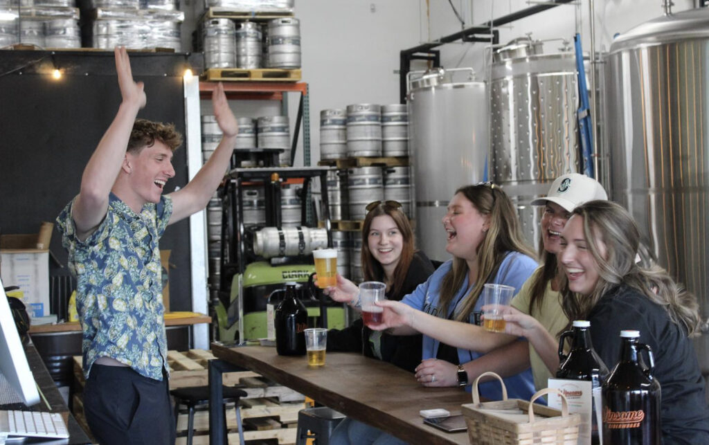 bartender at winsome cider celebrating with 4 other women holding cider glasses