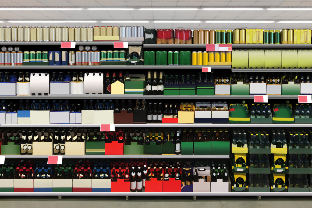 rows of different spirit and beer bottles in cans and cartons
