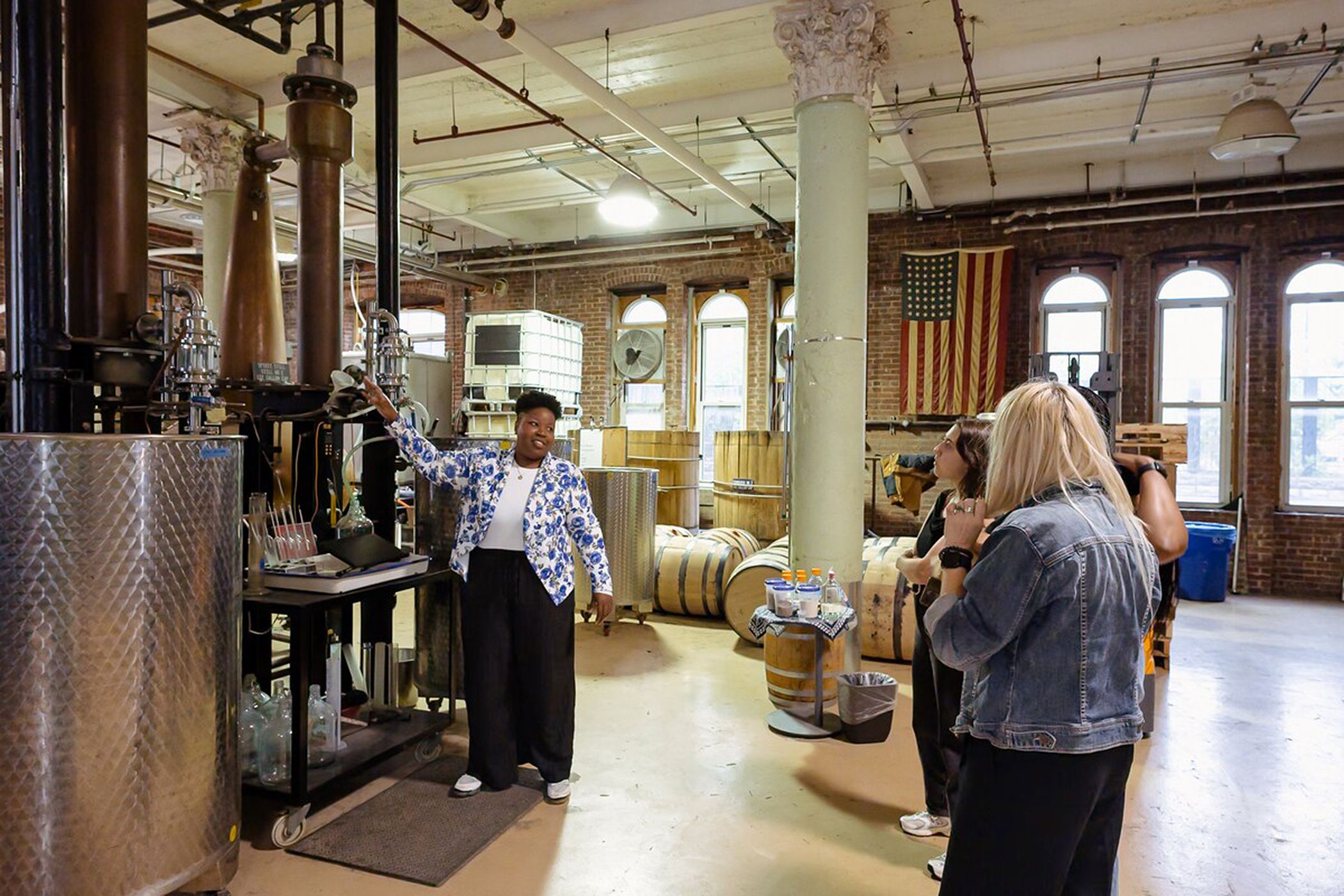 tour guide showing tourists Kings County Distillery