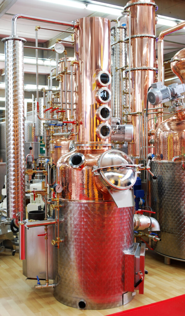 a copper still in a distillery